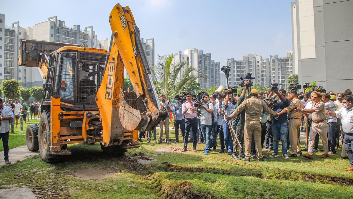 The action was carried out around 09:00 am by the Noida Authority to remove the illegal structures outside Tyagi's ground-floor apartment in Grand Omaxe society in Sector 93B, Noida. Credit: PTI Photo