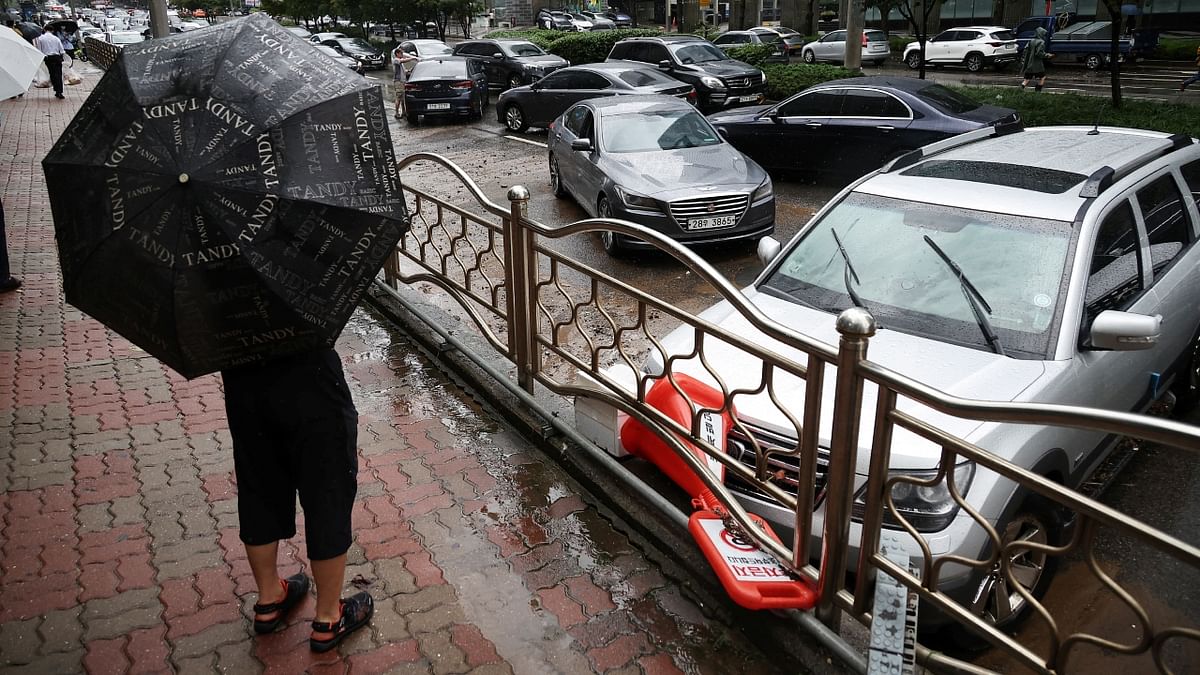 Commuters evacuated as water cascaded down the stairs of the Isu subway station like a waterfall. In the nearby city of Seongnam, a rain-weakened hillside collapsed into a university soccer field. Credit: Reuters Photo