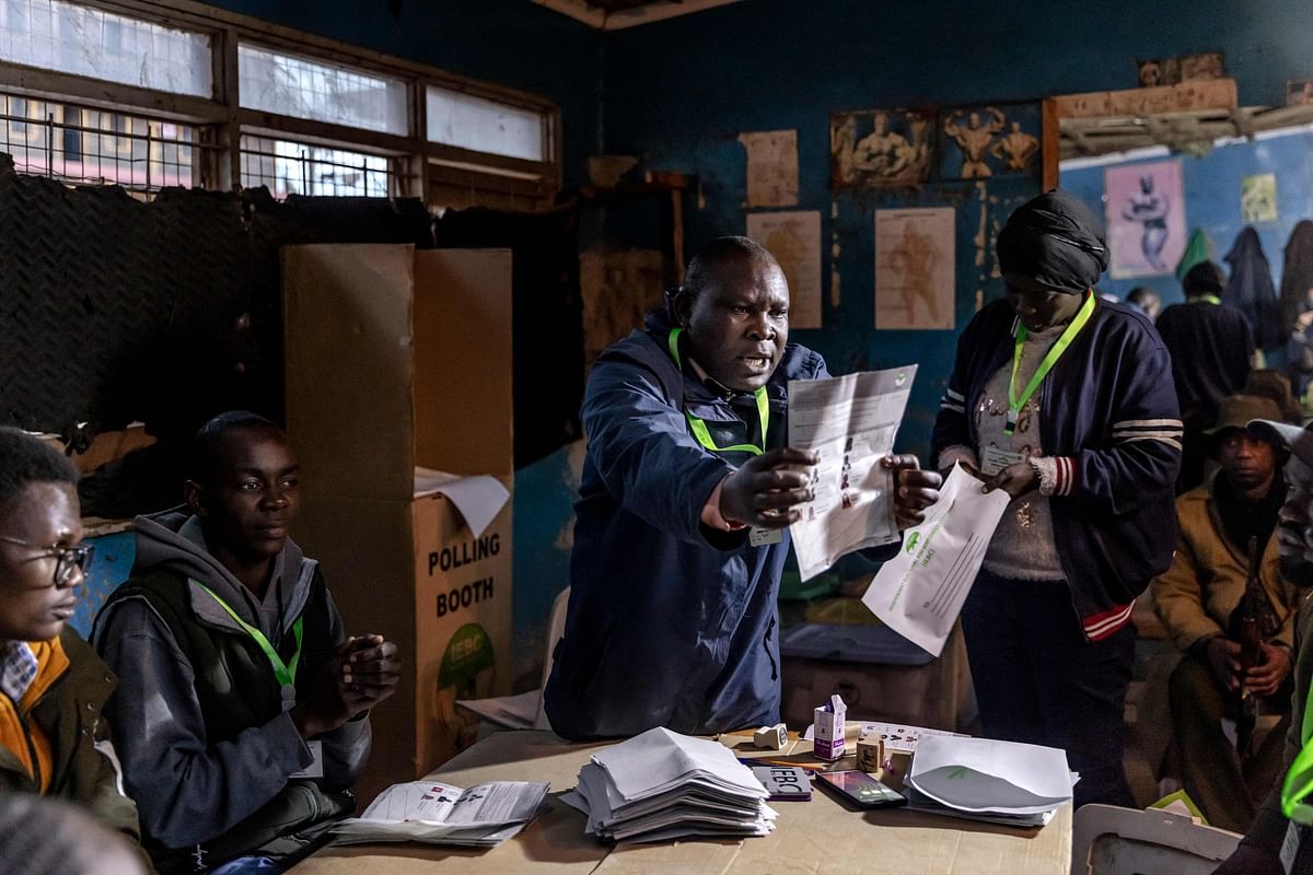 An Electoral Commission Official counts votes in front of observers and party representatives after the official closing of the polls during Kenya's general election at Mathare Social Hall in Nairobi. Credit: AFP Photo