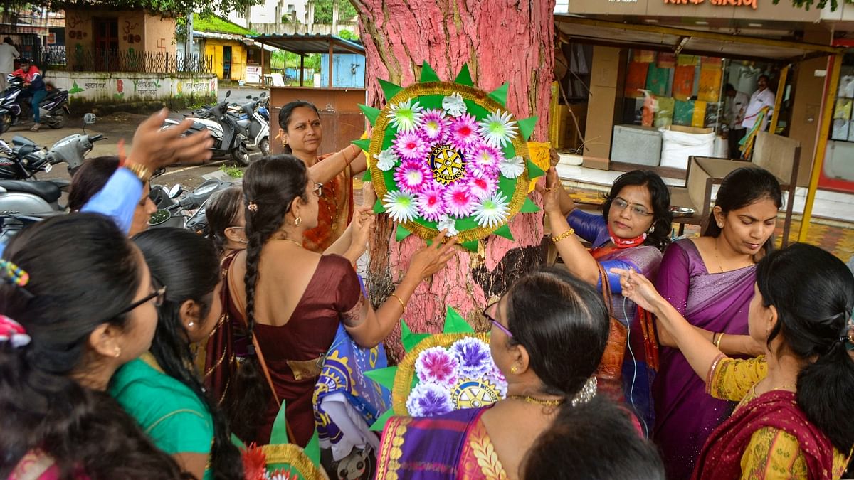 Women in Karad, Maharashtra tied 'Rakhi' to a tree on the occasion of the Raksha Bandhan festival. Credit: PTI Photo