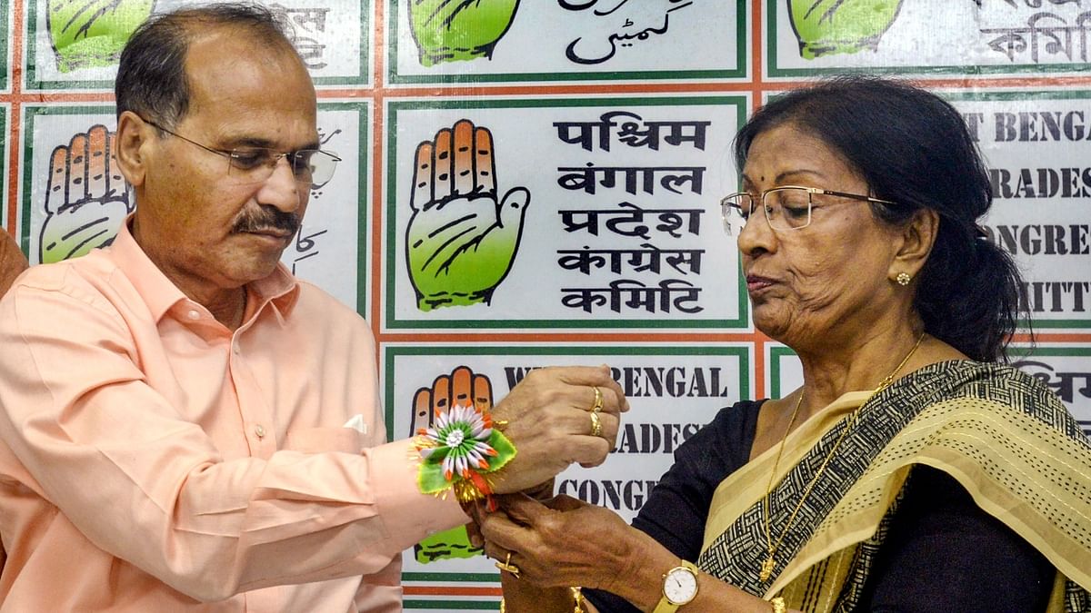 Congress leader Krishna Chakraborty tied rakhi on the wrist of MP Adhir Ranjan Chowdhury during a press conference in Kolkata. Credit: PTI Photo