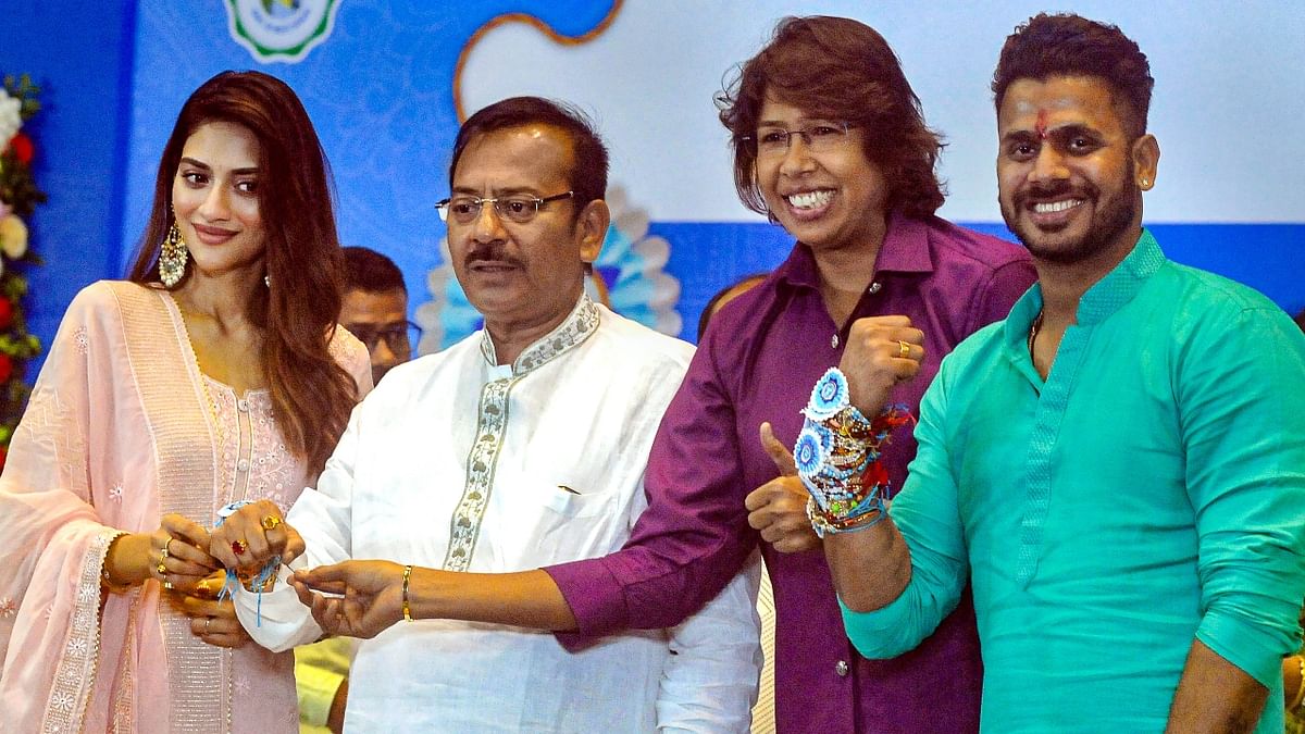 Actor and Trinamool Congress MP Nusrat Jahan and cricketer Jhulan Goswami tied a rakhi to West Bengal Sports Minister Aroop Biswas and Minister of State Manoj Tewari on Raksha Bandhan in Kolkata. Credit: PTI Photo