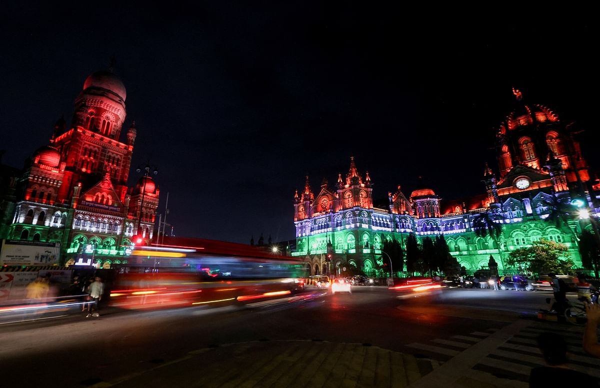 Traffic moves in front of the Brihanmumbai Municipal Corporation (BMC) building and the Chhatrapati Shivaji Maharaj Terminus (CSMT) as they are lit up in the colours of India's national flag ahead of the 75th Independence Day celebrations in Mumbai. Credit: Reuters Photo