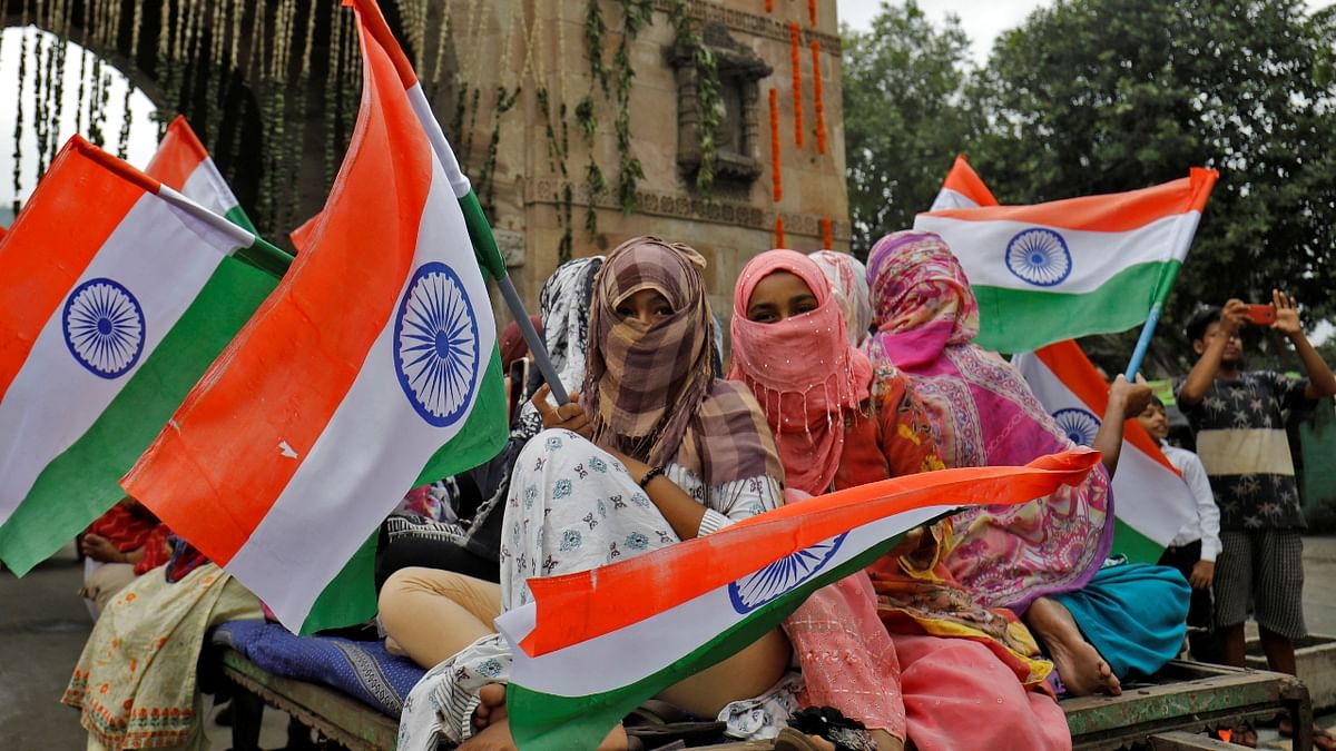 Women wave national flags as they take part in India's Independence Day celebrations in Ahmedabad. Credit: Reuters Photo