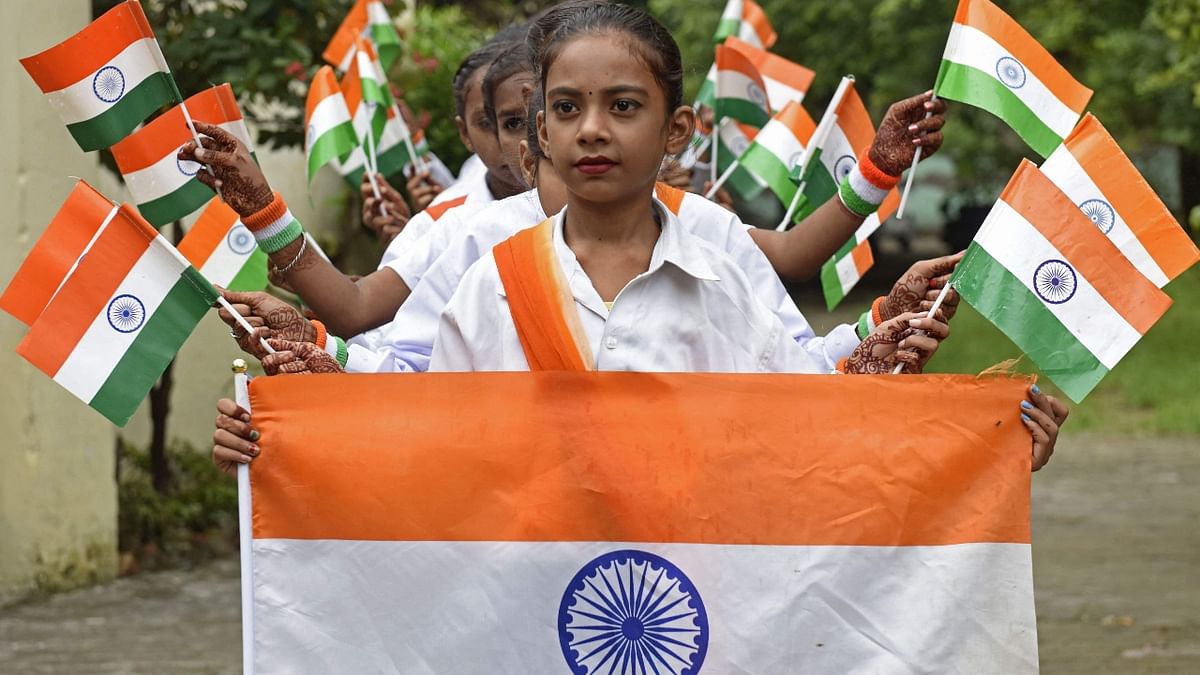 Children hold Indian national flags during the celebrations to mark 75th anniversary of India’s independence at a school in Amritsar. Credit: AFP Photo