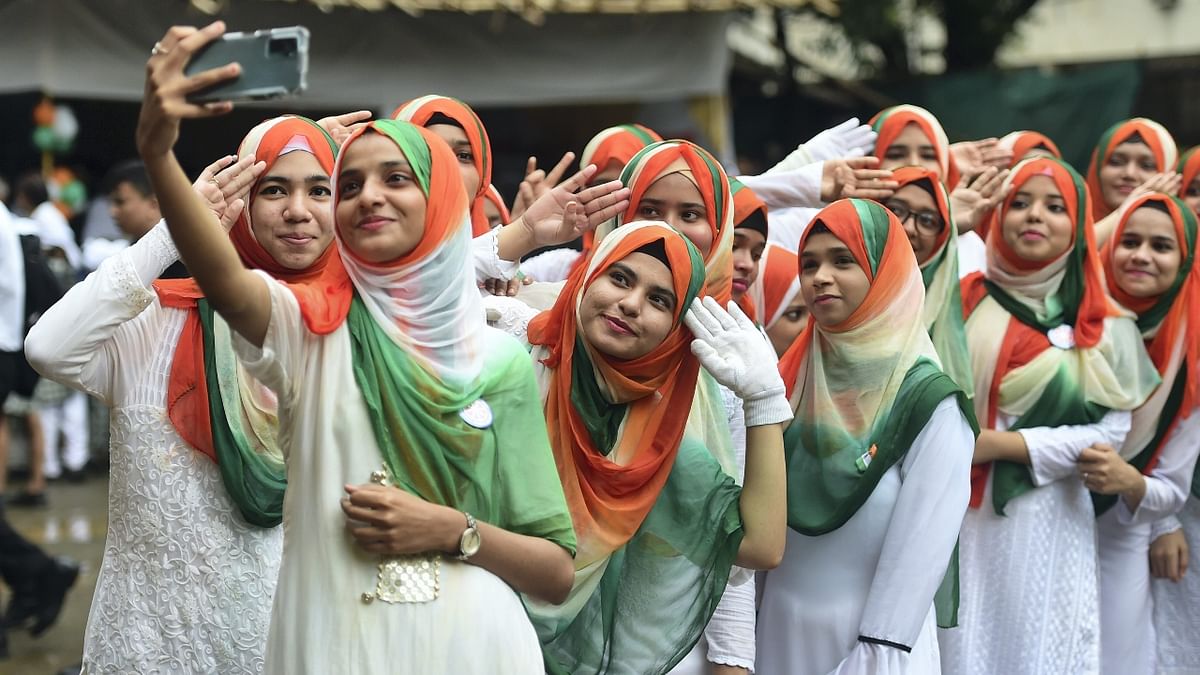 Students of Anjuman Islam College wearing tricoloured hijab take a selfie during a cultural programme organised on the occasion of 76th Independence Day, in Mumbai. Credit: PTI Photo