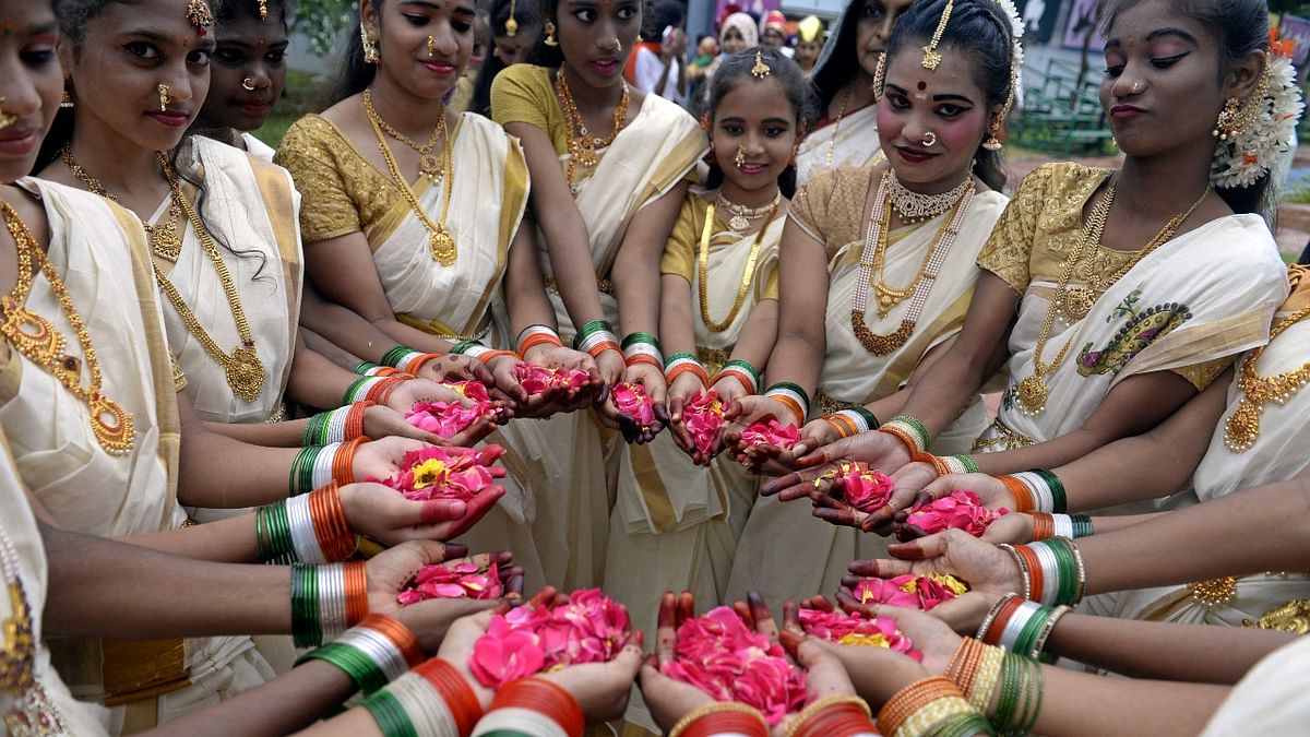 School students pose for pictures before participating in a ceremony to celebrate India's 75th Independence Day at the railway sports complex ground in Hyderabad. Credit: AFP Photo