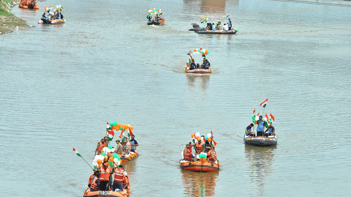 PAC jawans and flood-relief team hold a water-boat 'Tiranga Yatra' on the Ramganga river to celebrate the 76th Independence Day, in Moradabad. Credit: PTI Photo