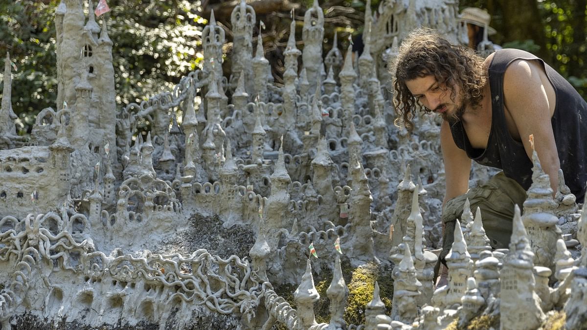 Swiss artist sculpts sprawling model castle on dried river bank
