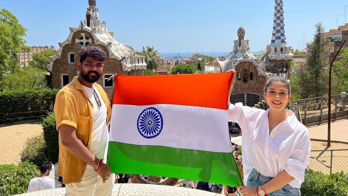 Nayanthara and Vignesh Shivan hold the Indian national flag during their holiday to Spain. Credit: Instagram/wikkiofficial