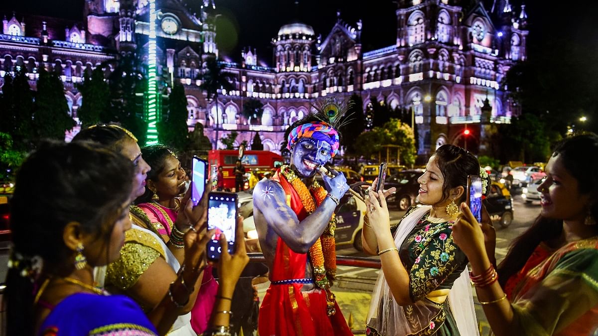 A boy dressed as Lord Krishna poses for a photo outside Chhatrapati Shivaji Maharaj terminus on 'Krishna Janmashtami' in Mumbai. Credit: PTI Photo