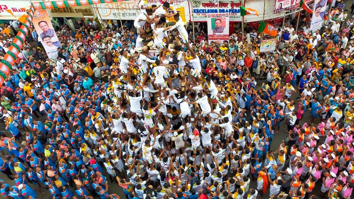 Devotees form a human pyramid to break 'dahi-handi', an earthen pot filled with curd suspended in the air, during the celebrations of the 'Janmashtami' festival at Dadar. Credit: PTI Photo