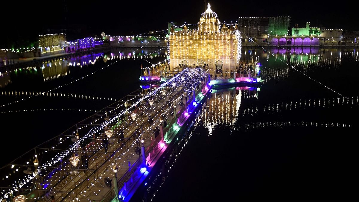 Devotees visit the illuminated Durgiana Temple on the eve of 'Janmashtami' festival, marking the birth of Lord Krishna, in Amritsar. Credit: AFP Photo