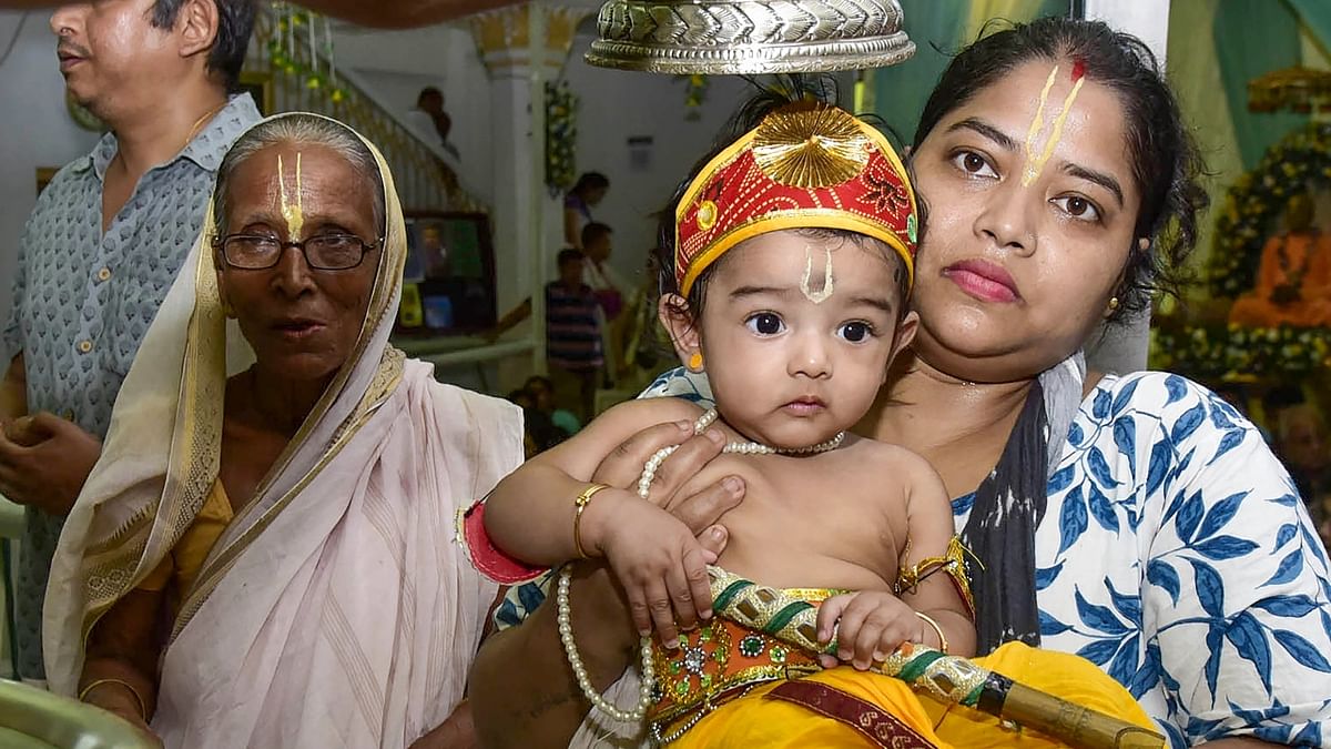 A child dressed as Lord Krishna being blessed by a priest on the occasion of 'Janmashtami', at an ISKCON temple in Guwahati. Credit: PTI Photo