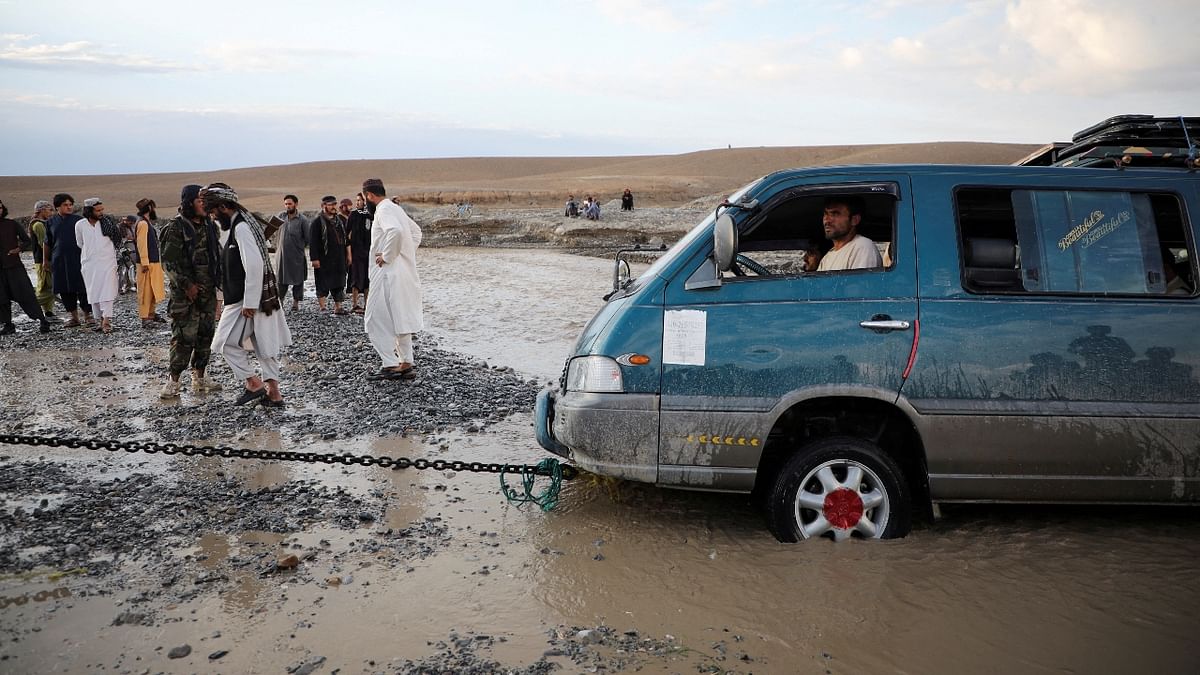 A minivan is being towed out of the flood water in the Khushi district of Logar, Afghanistan. Credit: Reuters Photo