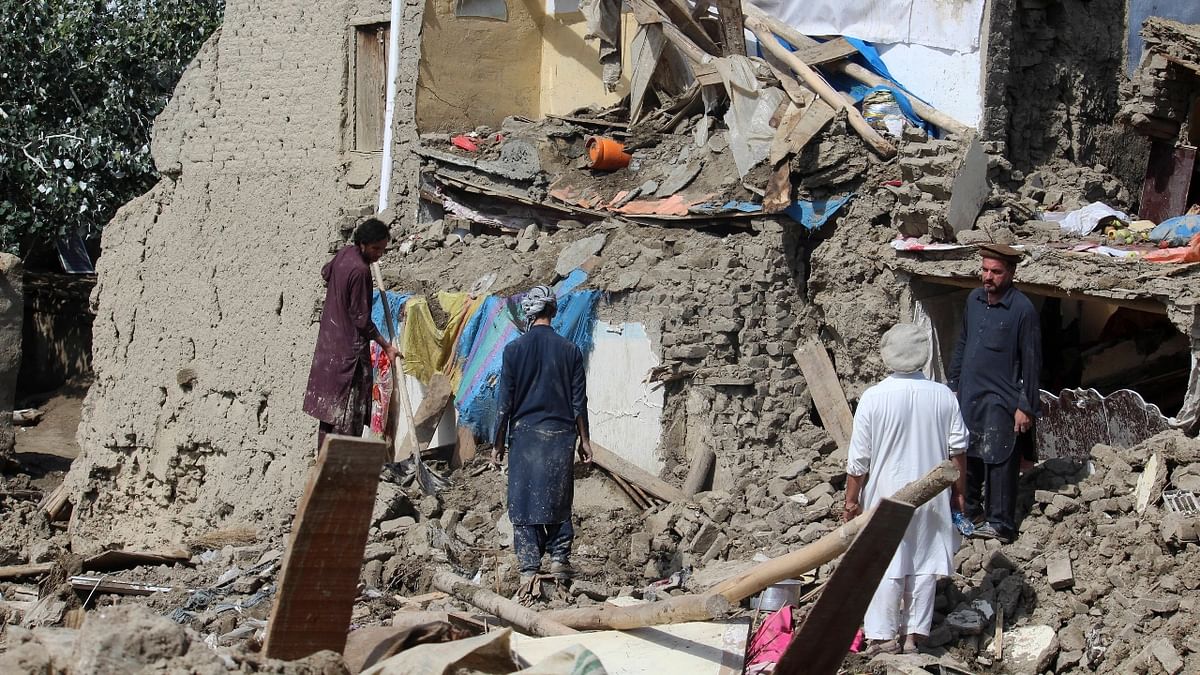 People clean up their damaged homes after heavy flooding in the Khushi district of Logar province south of Kabul, Afghanistan. Credit: AP Photo