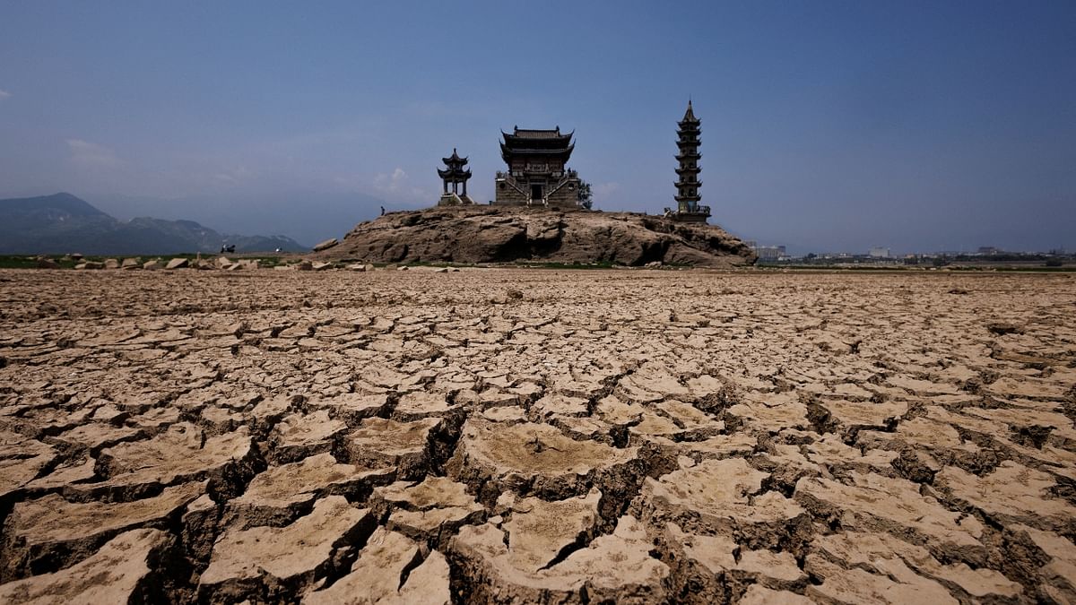 A view of pagodas on Louxingdun island that usually remains partially submerged under the water of Poyang Lake which is facing low water levels due to a regional drought in Lushan, Jiangxi province, China. Credit: Reuters Photo