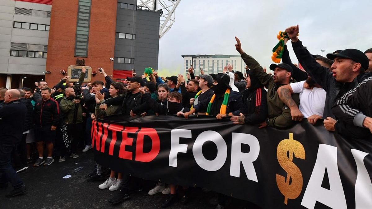 Protesters gather outside Old Trafford stadium to demonstrate against Manchester United's owners ahead of the English Premier League football match between Manchester United and Liverpool at Old Trafford in Manchester. Credit: AFP Photo