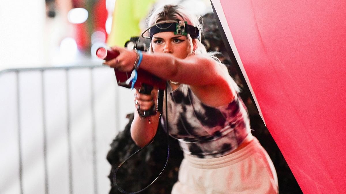 A woman plays a laser-tag game at the Gamescom 2022 in Cologne, Germany. Credit: Reuters Photo