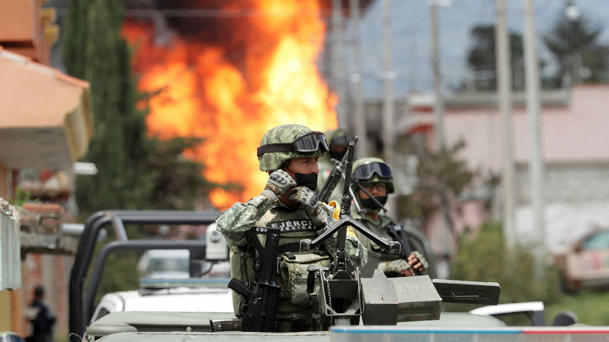 Mexican soldiers guard the perimeter set by authorities due to the explosion of a gas pipeline during maintenance work performed by personnel of Mexican state oil company Pemex, in Amozoc de Mota, in Puebla state, Mexico August 26, 2022. Credit: Reuters Photo