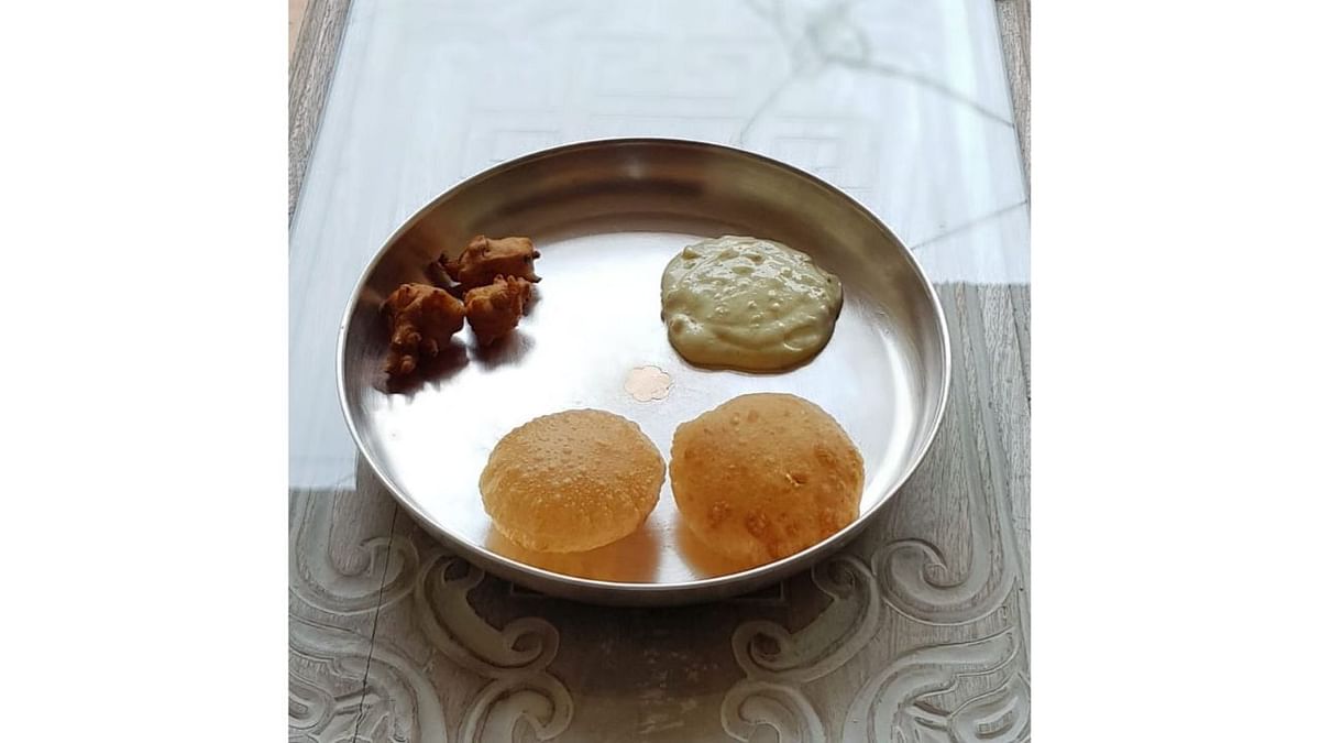 Shrikhand Puri: The delectable combo consists of crispy puri made from refined flour and a sweet dish prepared from strained yoghurt topped with nuts. Credit: Instagram/rujuta.diwekar