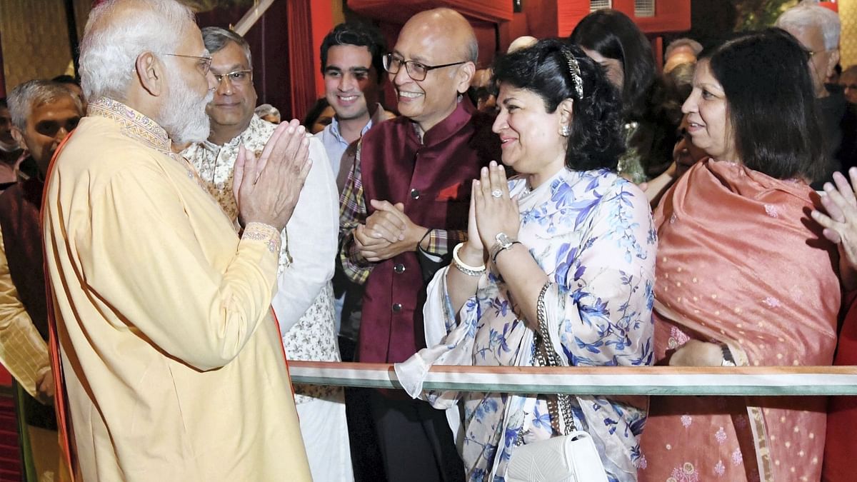 PM Modi and Abhishek Manu Singhvi exchange greetings during the 'Ganesh Chaturthi' celebrations at Goyal's residence. Credit: PTI Photo