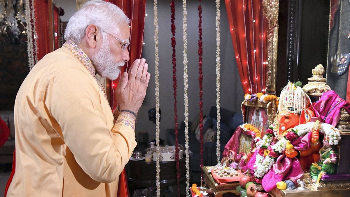 Prime Minister Narendra Modi offers prayers during the 'Ganesh Chaturthi' celebrations at Piyush Goyal's residence, in New Delhi. Credit: PTI Photo