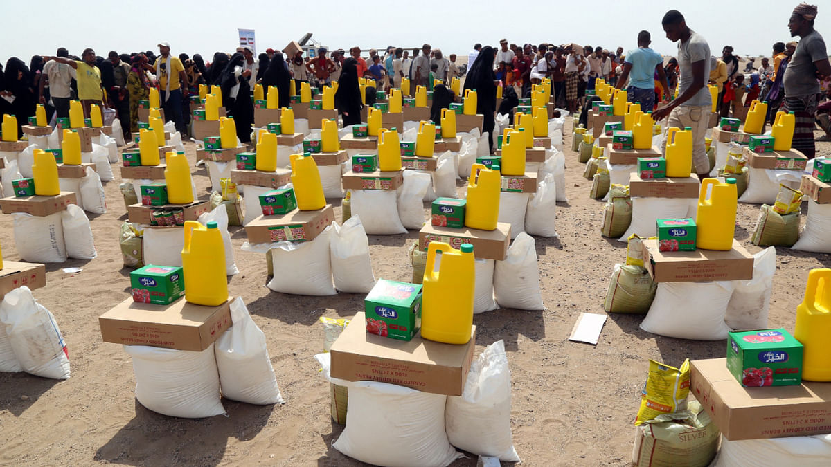 Yemenis displaced by the conflict, receive food aid and supplies to meet their basic needs, at a camp in Hays district in the war-ravaged western province of Hodeida on August 31, 2022. Credit: AFP Photo