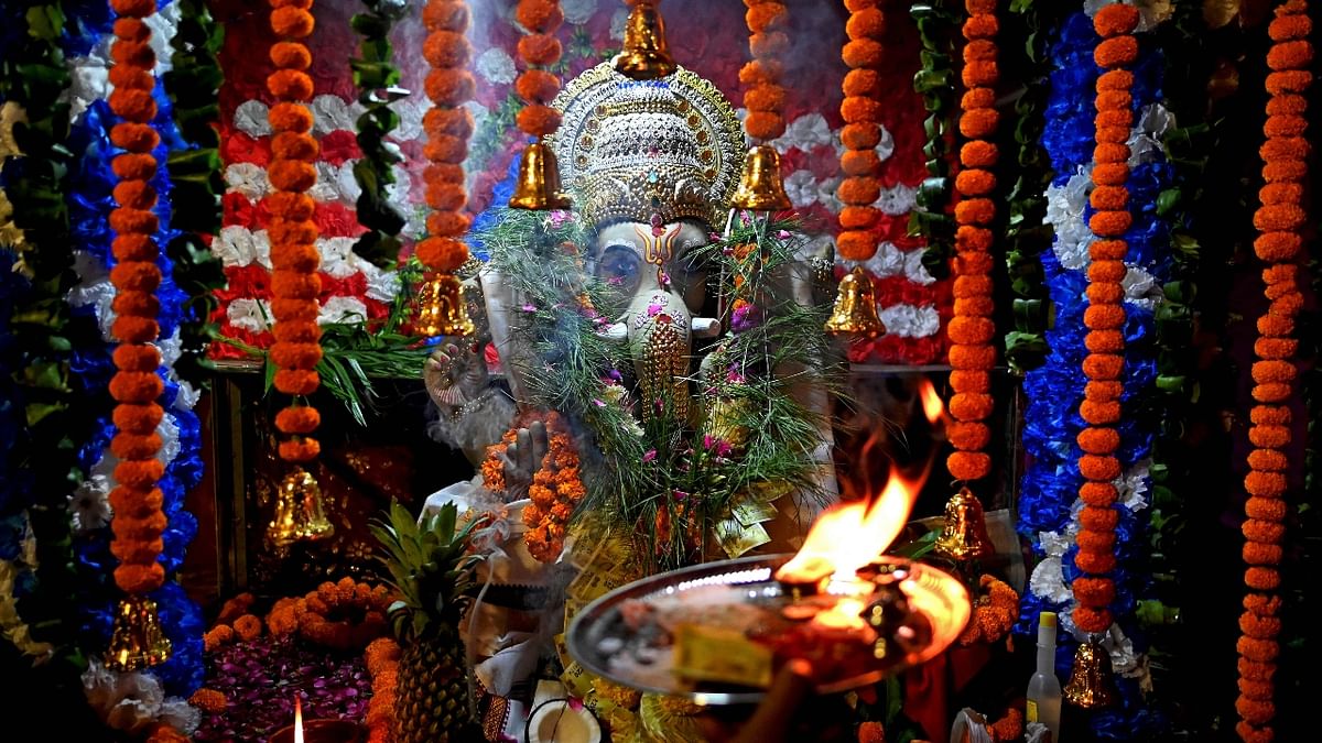 A priest offers prayers to Lord Ganesha in a pandal during the Ganesh Chaturthi festival in New Delhi. Credit: AFP Photo