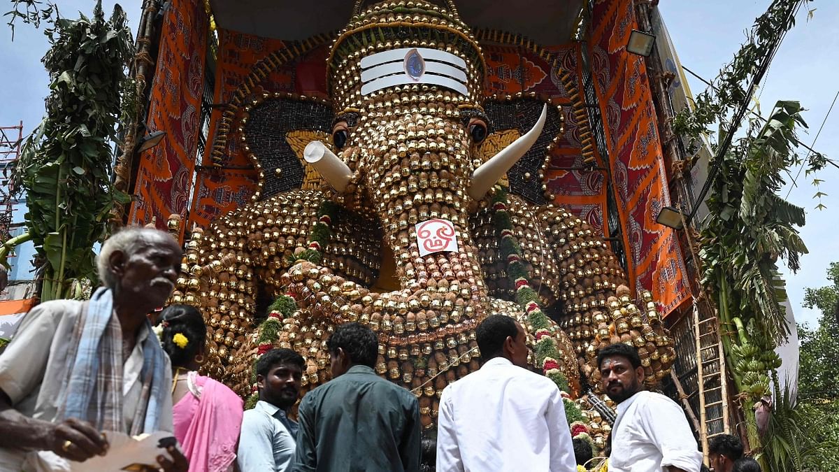 Devotees gather to see a 30-foot tall idol Ganesha made of metal pots, coconuts, corn and sugarcane on the occasion of the Ganesh Chaturthi festival in Chennai. Credit: AFP Photo