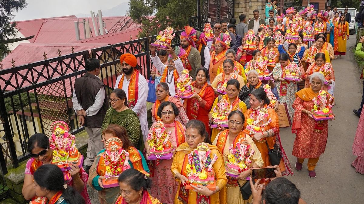 Devotees carry idols of Lord Ganesha during a procession on the occasion of Ganesh Chaturthi in Shimla. Credit: PTI Photo