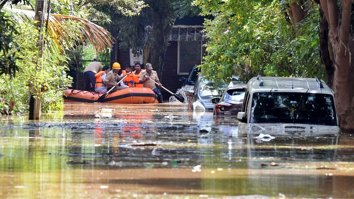 Using boats and tractors to cross the streets submerged in water by office goers and school children was a common sight this morning in several parts of the city like Yemalur, Rainbow Drive layout, Sunny Brooks Layout, Marathahalli among several others. Credit: Reuters Photo