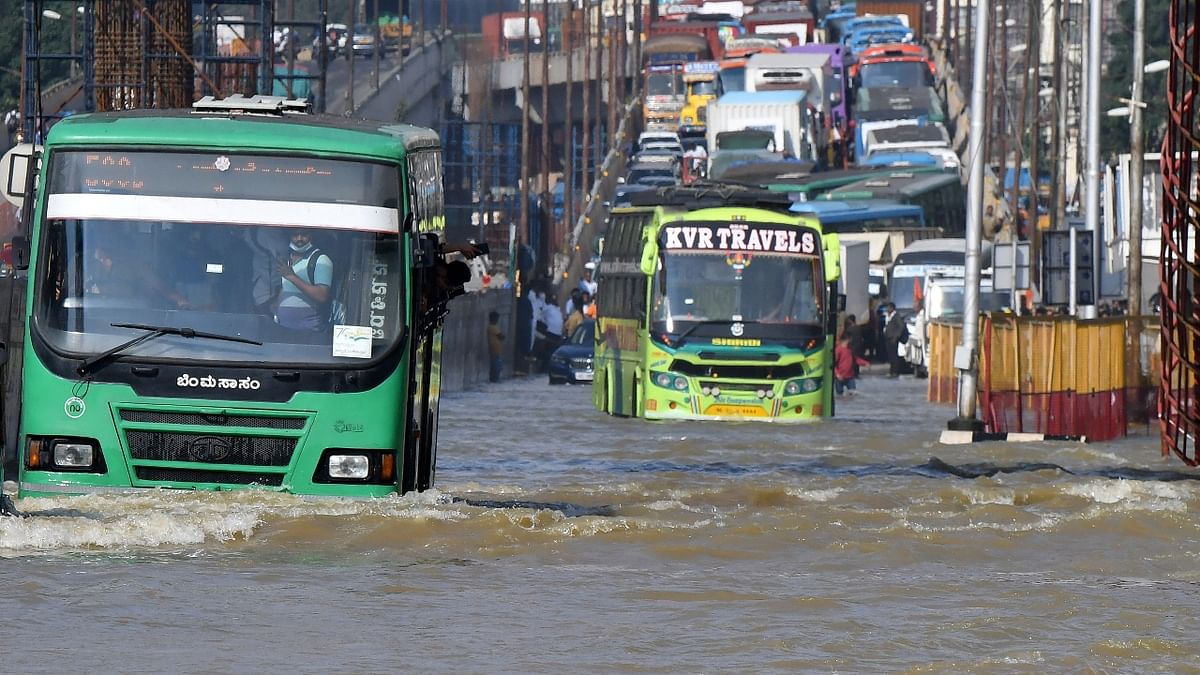 Vehicles ply on a waterlogged road following torrential rains in Bengaluru. Credit: Reuters Photo