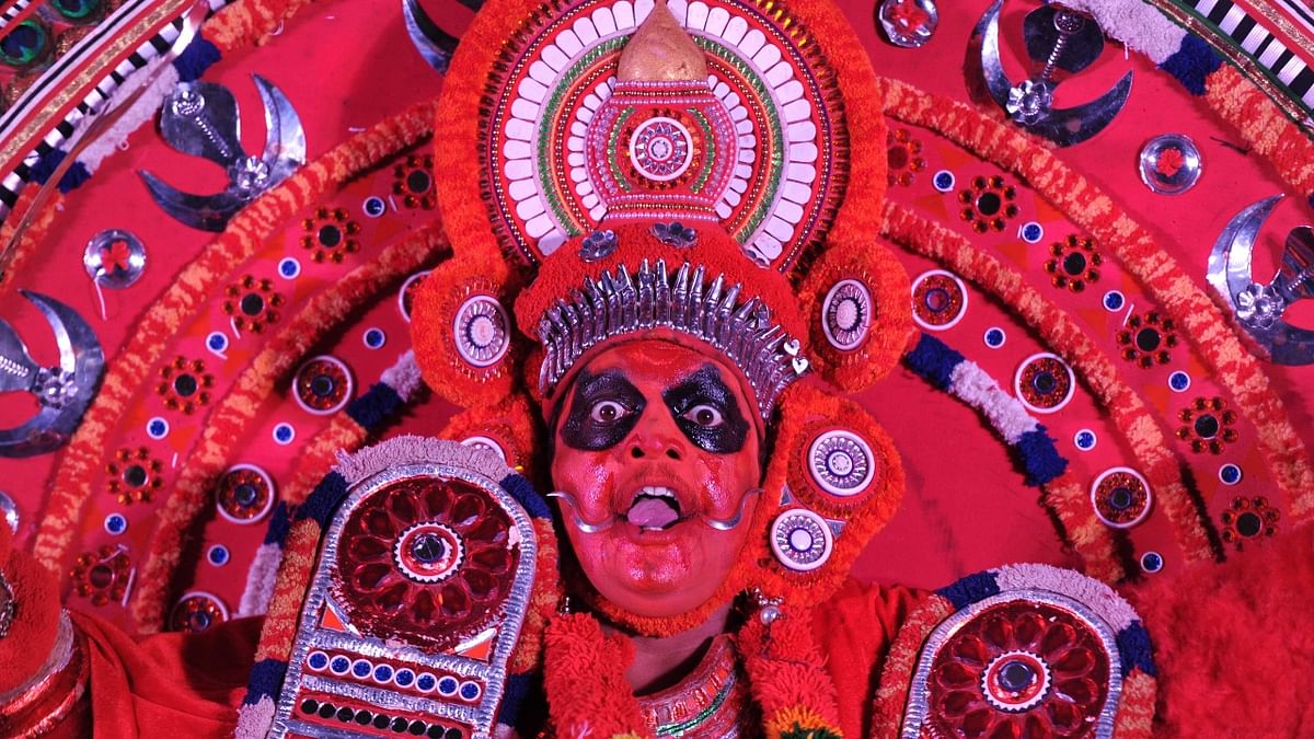 Theyyam: Theyyam is a popular form of worship performed in Kerala to commemorate Onam and can be witnessed in the North Malabar region. The performers of Theyyam are considered as 'Gods' by the people. Many people also seek blessing of these performers. Credit: AFP Photo