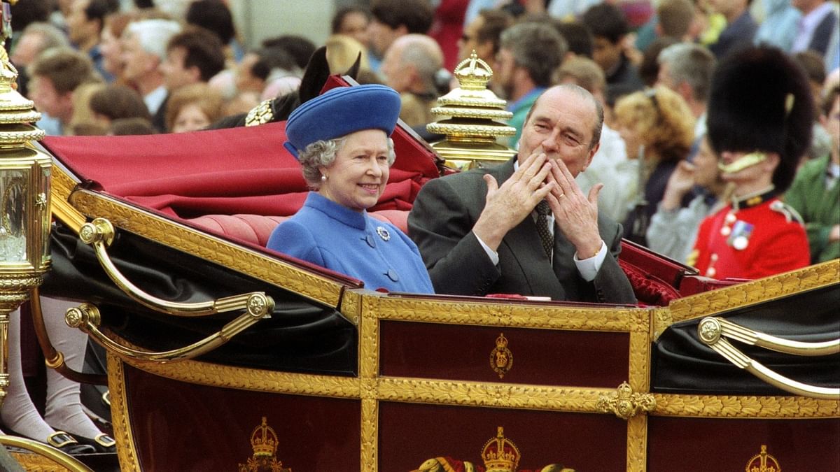 Queen Elizabeth II and French President Jacques Chirac ride in an open landau to Buckingham Palace in London at the start of his state visit to Britain on May 14, 1996. Credit: AFP Photo