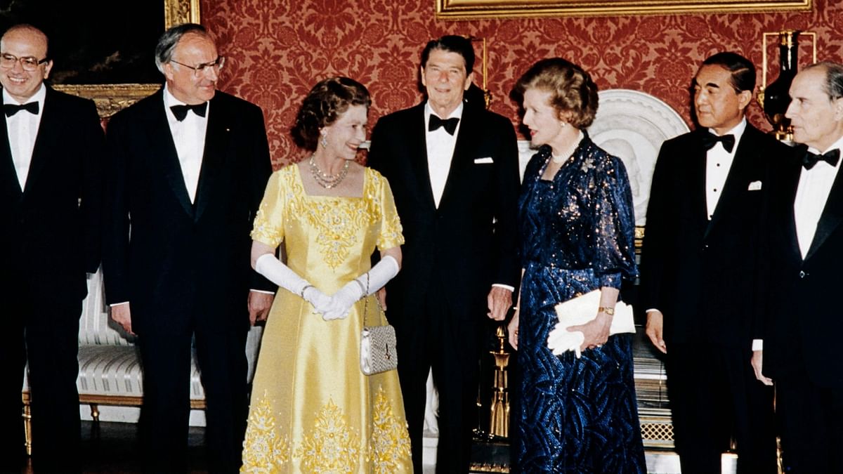 Queen Elizabeth II poses with Economic Summit leaders: (from L to R) French President François Mitterrand, Japanese Prime Minister Yasuhiro Nakasone, British Prime Minister Margaret Thatcher, US President Ronald Reagan, Chancellor Helmut Kohl of West Germany and Italian Prime Minister Bettino Craxi at Buckingham Palace on September 06, 1984. Credit: AFP Photo