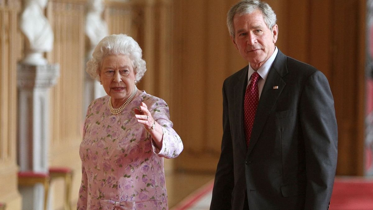 Queen Elizabeth II leads US President George W Bush in a tour of St George's Hall at Windsor Castle, in Windsor, Berkshire, west of London, 2008. Credit: AFP Photo