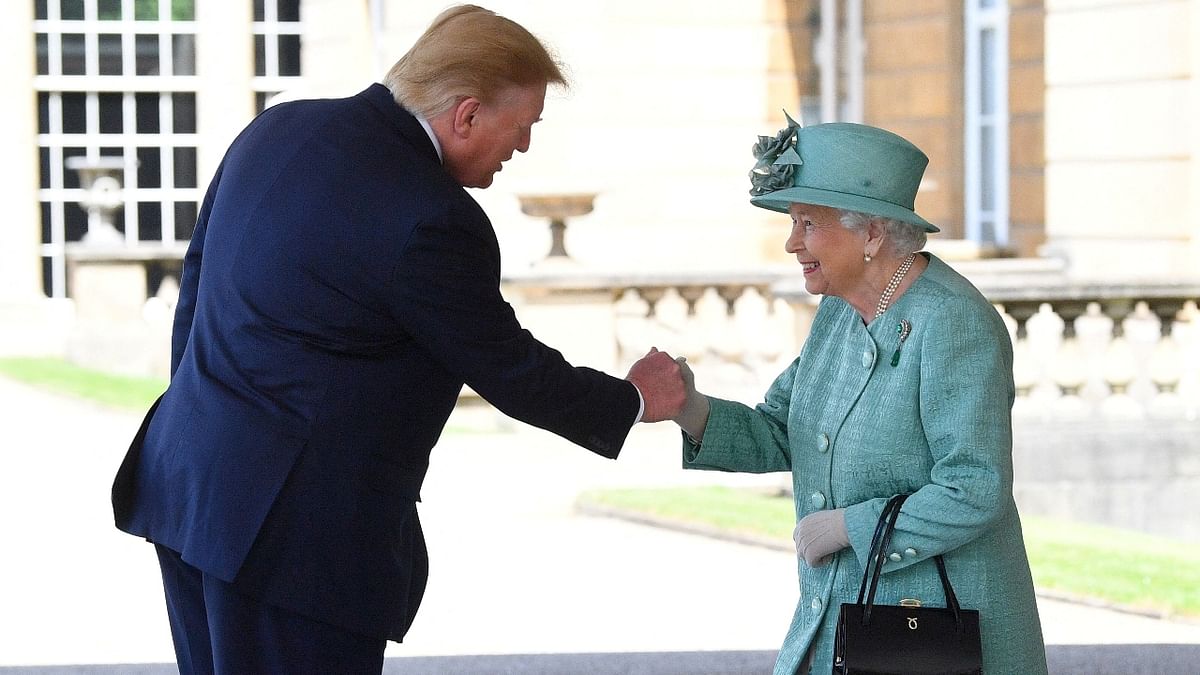 Queen Elizabeth II greets US President Donald Trump as he arrives for the Ceremonial Welcome at Buckingham Palace, in London in 2019. Credit: Reuters Photo