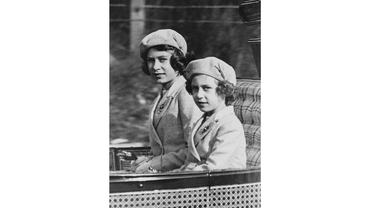 Princess Elizabeth (later Queen Elizabeth II) and Princess Margaret (1930-2002) ride in a carriage with the King and Queen to Crathie Kirk from Balmoral Castle to attend a morning service, in Scotland on 9th October 1938. Credit: Getty Images