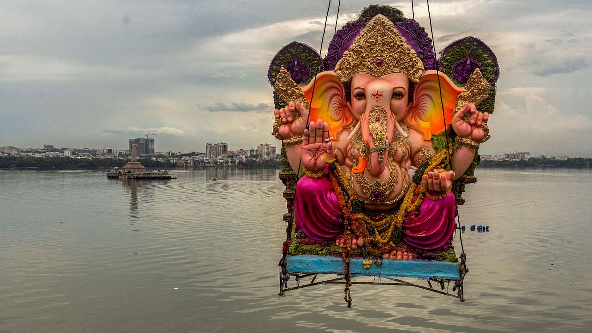 An idol of Lord Ganesha being immersed at Hussain Sagar Lake in Hyderabad. Credit: PTI Photo