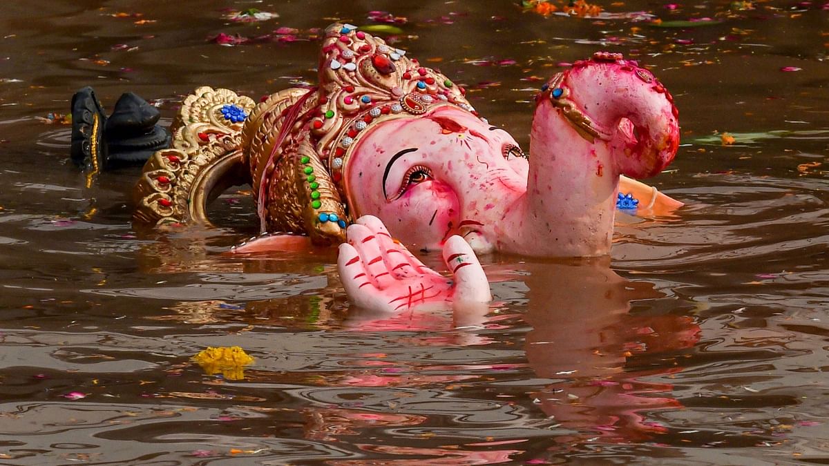 An idol of Lord Ganesha after being immersed in an artificial pond on the last day of Ganesh Chaturthi, in Delhi. Credit: PTI Photo