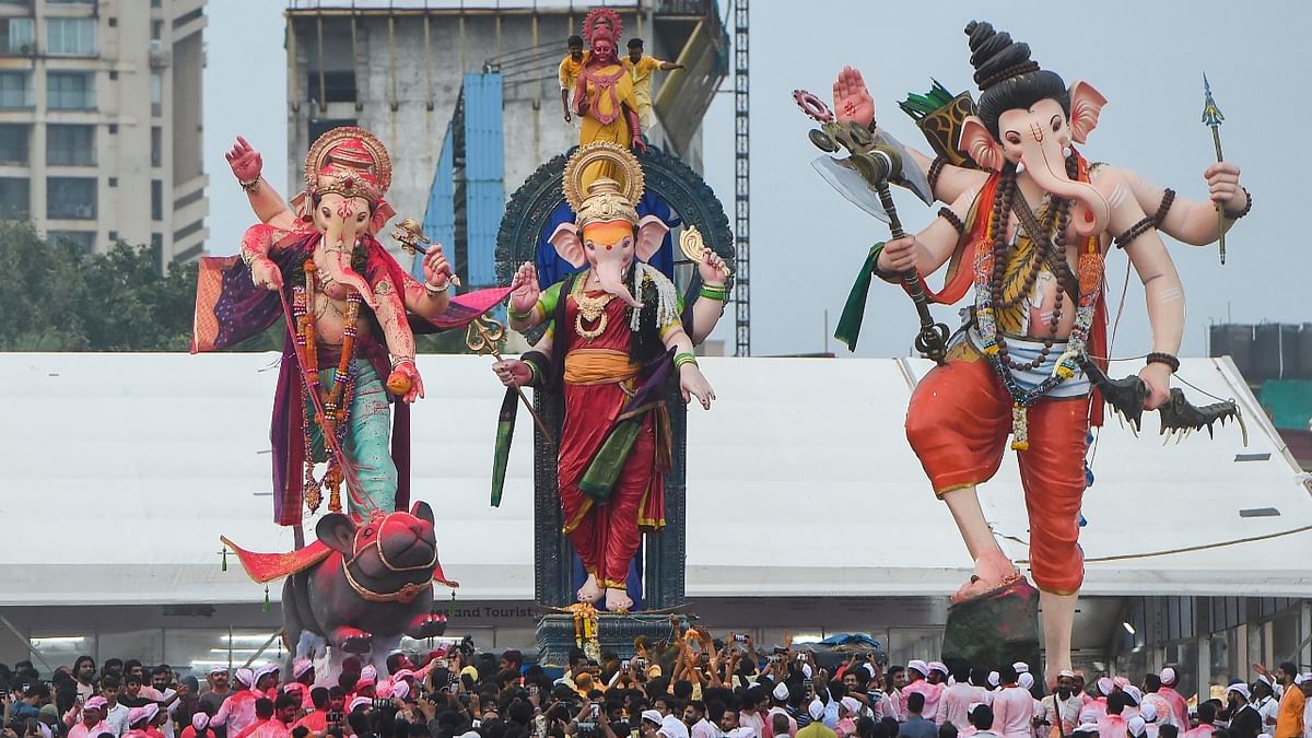 Devotees carry idols of Lord Ganesha for immersion in the Arabian sea, at Girgaon Chowpatty in Mumbai. Credit: PTI Photo