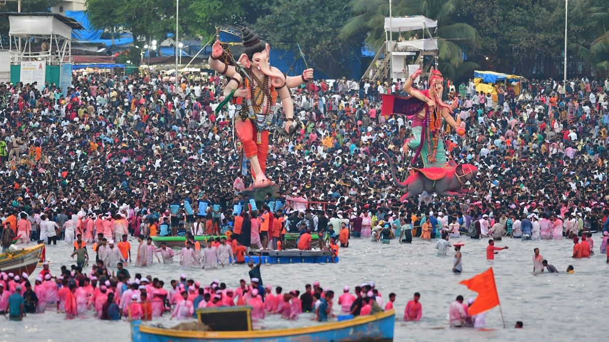 Devotees carry idols of Lord Ganesha for immersion in the Arabian sea, at Girgaon Chowpatty in Mumbai. Credit: PTI Photo