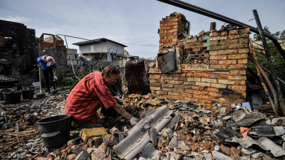 Volunteers clear the rubble of a destroyed house as a result of shelling in village of Moshchun, Kyiv region, on September 9, 2022, amid the Russian military invasion of Ukraine. Credit: AFP Photo