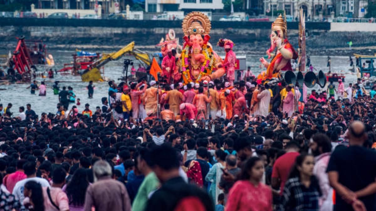 Devotees during immersion of 'Lalbaugcha Raja' idol of Lord Ganesh at Girgaon Chowpatty, in Mumbai, Saturday, Sept. 10, 2022. Credit: PTI Photo