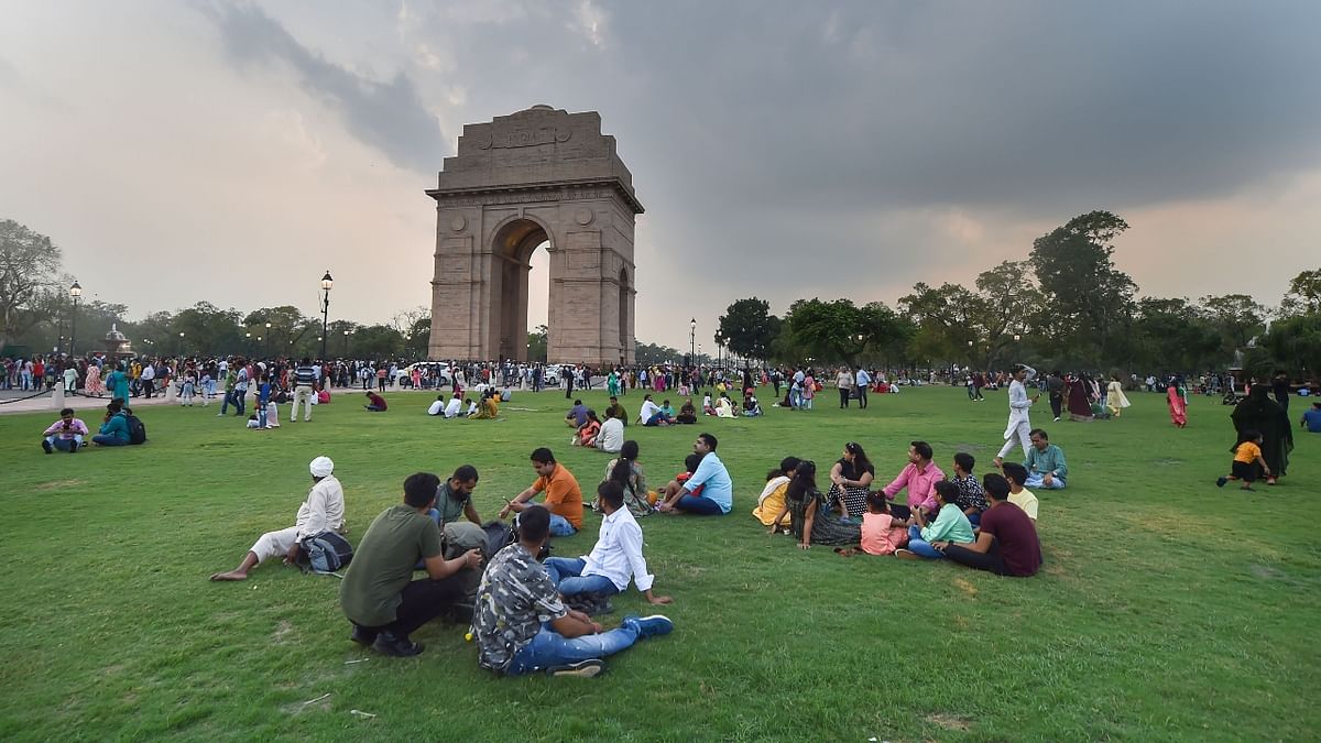 People leisure on the lawns of India Gate, at Kartavya Path in New Delhi. Credit: PTI Phot