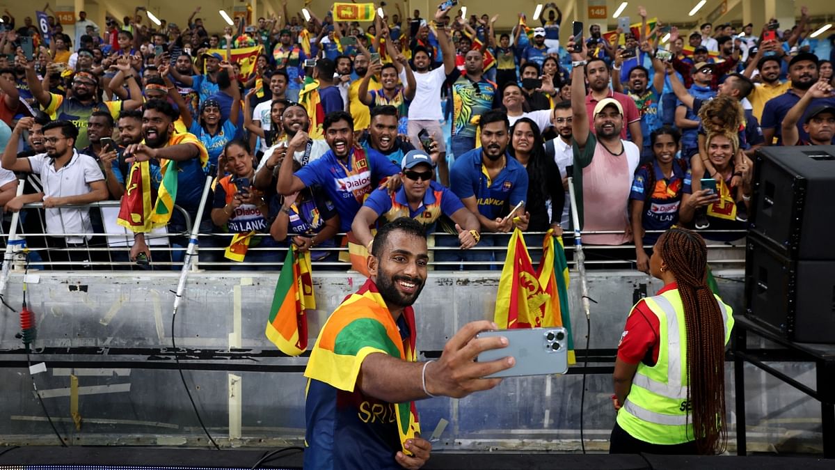 Sri Lanka's Chamika Karunaratne celebrates the win with the fans. Credit: Reuters Photo
