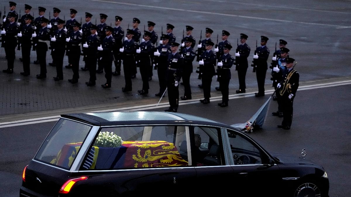 The coffin of Queen Elizabeth II carried in the royal hearse is seen leaving RAF Northolt in London, before being taken to Buckingham Palace. Credit: Reuters Photo