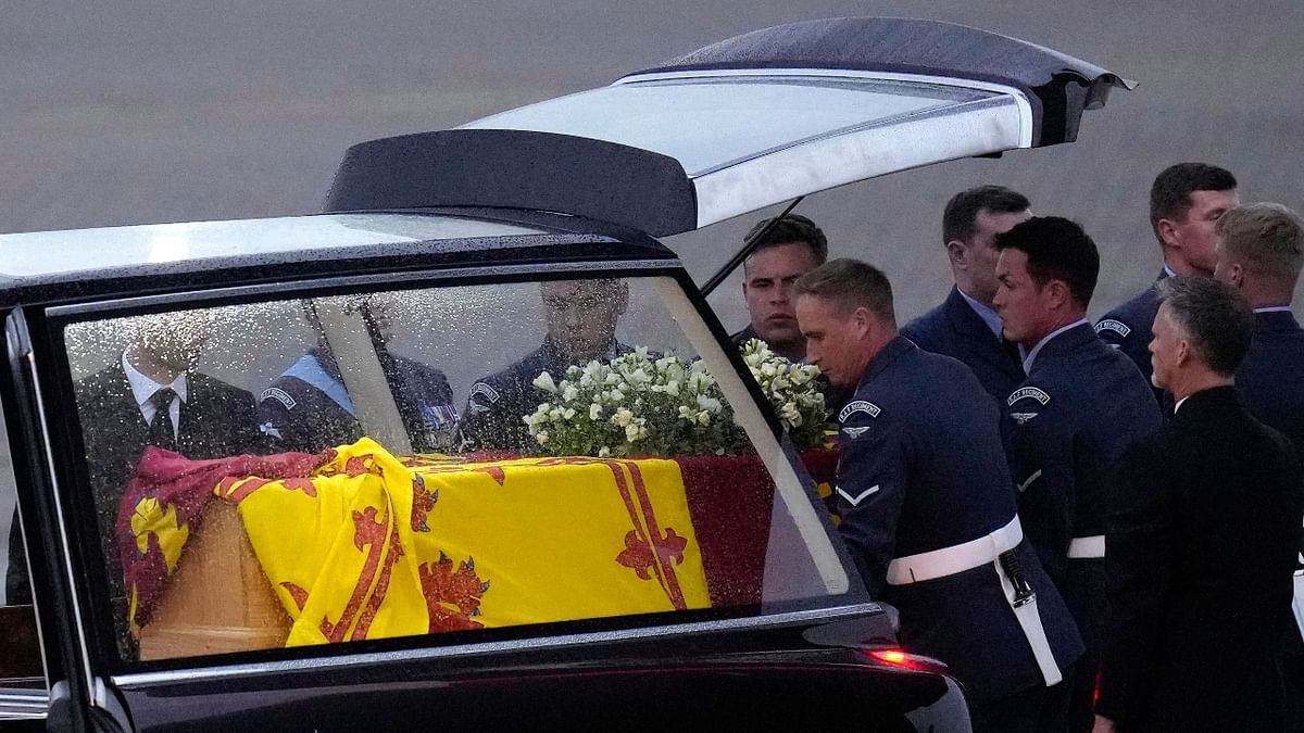 Pallbearers from the Queen's Colour Squadron (63 Squadron RAF Regiment) place the coffin of Queen Elizabeth II in the royal hearse, having removed it from the C-17 at the Royal Air Force Northolt airbase. Credit: Reuters Photo