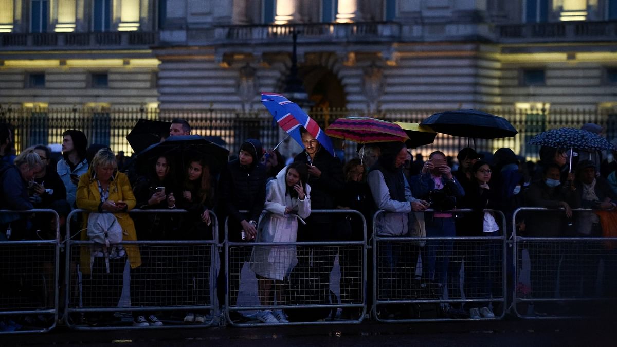 Since early Tuesday, people had flocked to the Mall, the road leading to the front of Buckingham Palace, and by the evening, thousands were lining the streets of the route from the air force base, wearing rain jackets or holding umbrellas as the royal hearse drove by. Credit: Reuters Photo